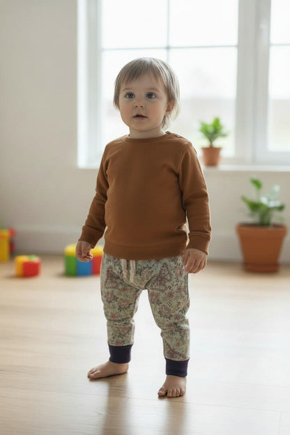 peuter draagt slank broekje voor wasbare luiers, donkergroen met vlinders